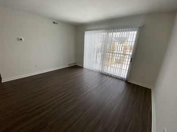 A spacious living room with vinyl plank flooring